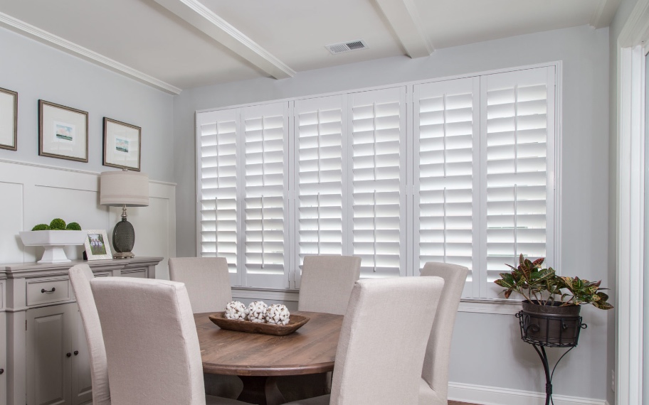 Plantation shutters in a cozy dining room.